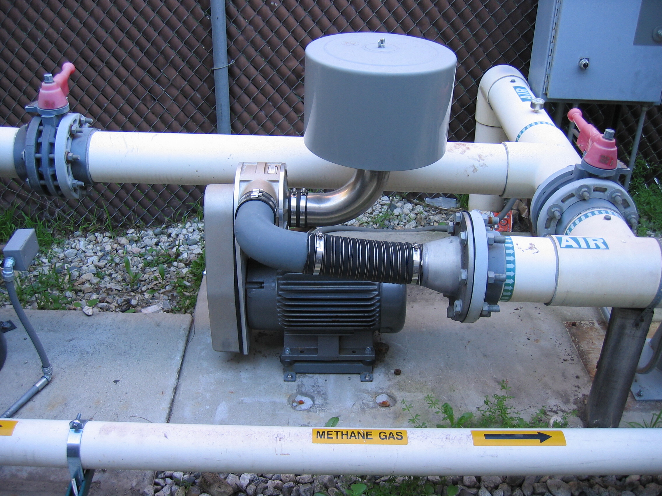 Centrifugal blower connected to air and methane gas piping at an outdoor remediation installation