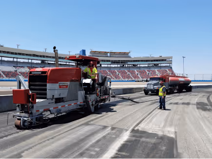 Concrete finishing machinery operating on a paved surface